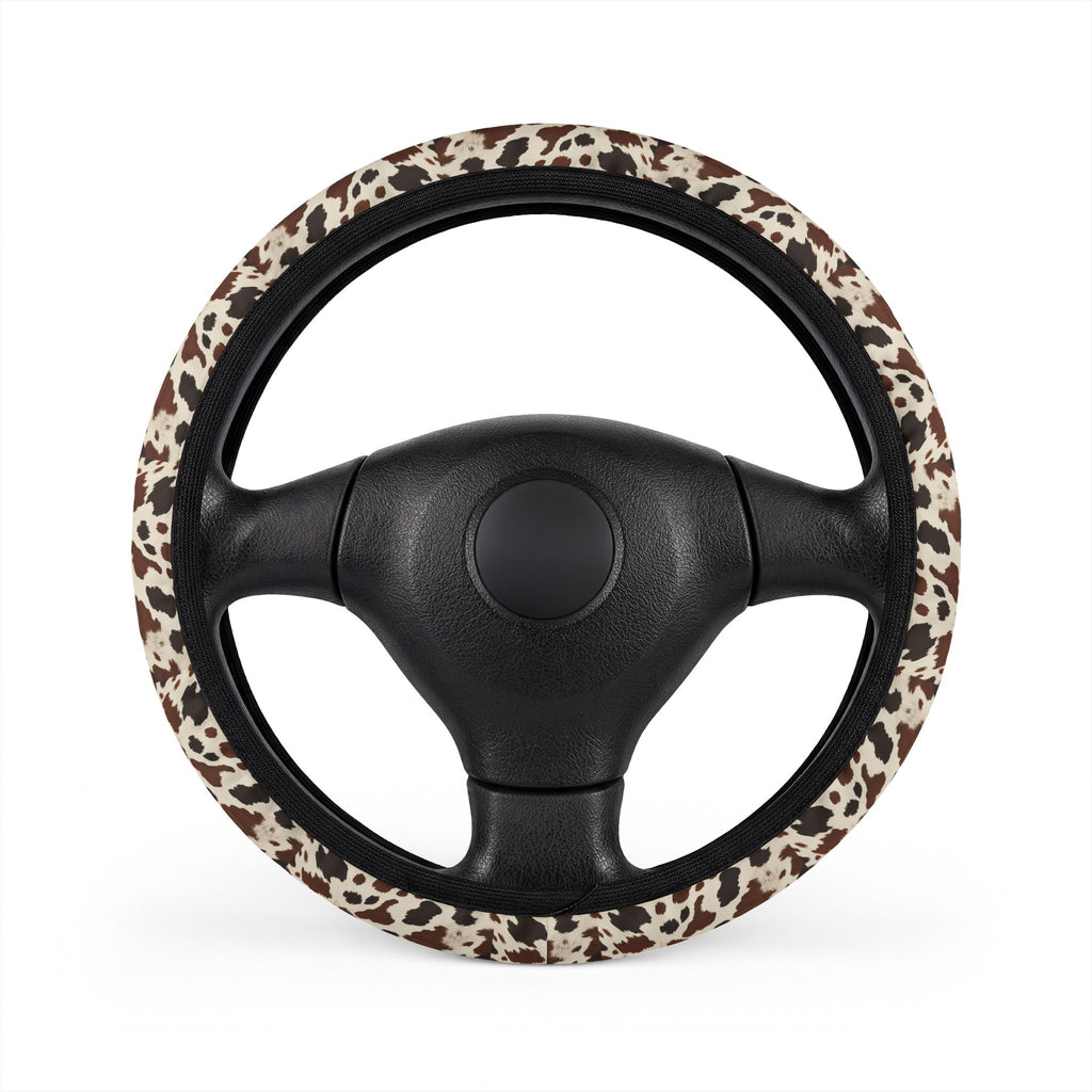 Black brown cow print steering wheel cover, on a steering wheel