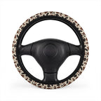 Black brown cow print steering wheel cover, on a steering wheel