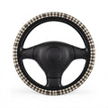 Black brown houndstooth steering wheel cover, on a steering wheel