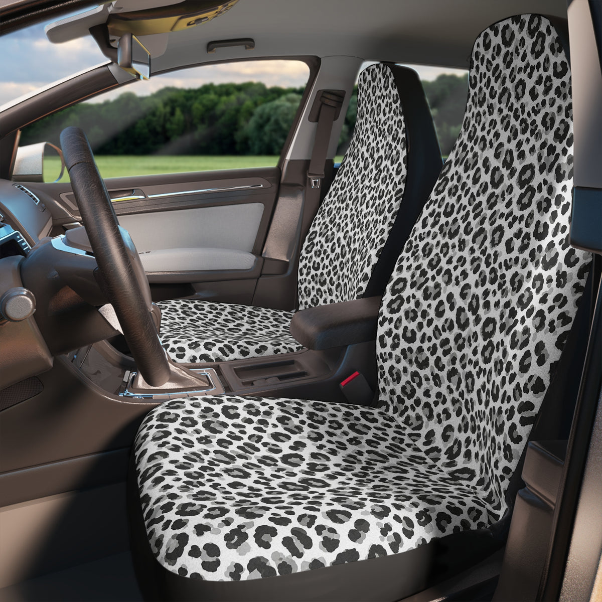 Black white cheetah print car seat covers, fitted on the front seats of a car