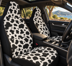 Black white cow print car seat covers shown in a car interior