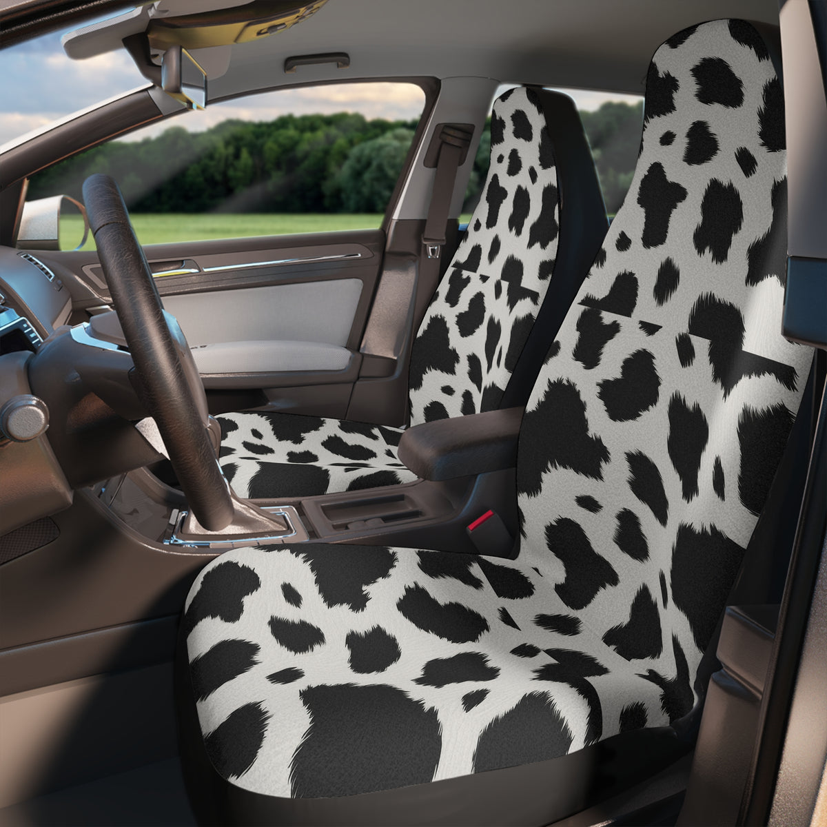 Black white cow print car seat covers, fitted on the front seats of a car