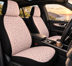Light pink leopard print car seat covers shown in a car interior