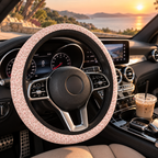 Light pink leopard print steering wheel cover shown in a car interior