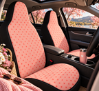 Pink polka dot car seat covers shown in a car interior