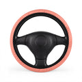 Pink polka dot steering wheel cover, on a steering wheel