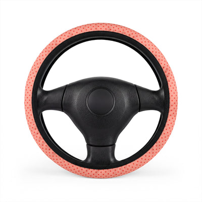Pink polka dot steering wheel cover, on a steering wheel