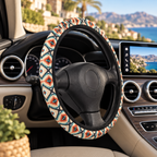 Teal aztec diamond steering wheel cover shown in a car interior