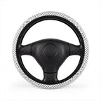 White big polka dot steering wheel cover, on a steering wheel