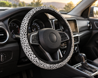 White leopard print steering wheel cover shown in a car interior